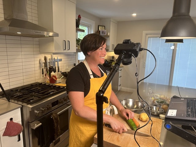 Kirstie filming during a cooking class